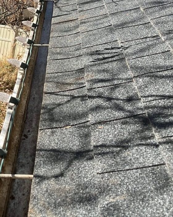 After gutter cleaning, the same gutter is clear of leaves and debris.