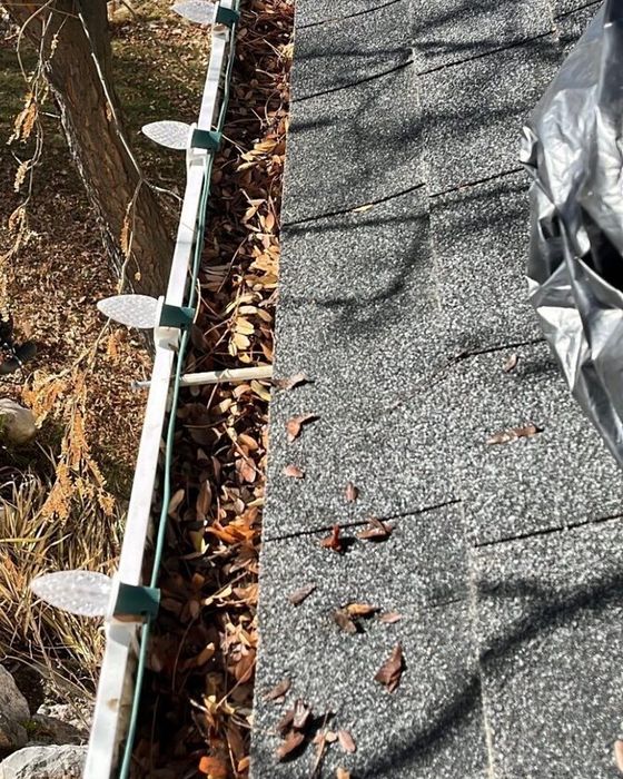 Before gutter cleaning, the gutter is packed with leaves and debris.