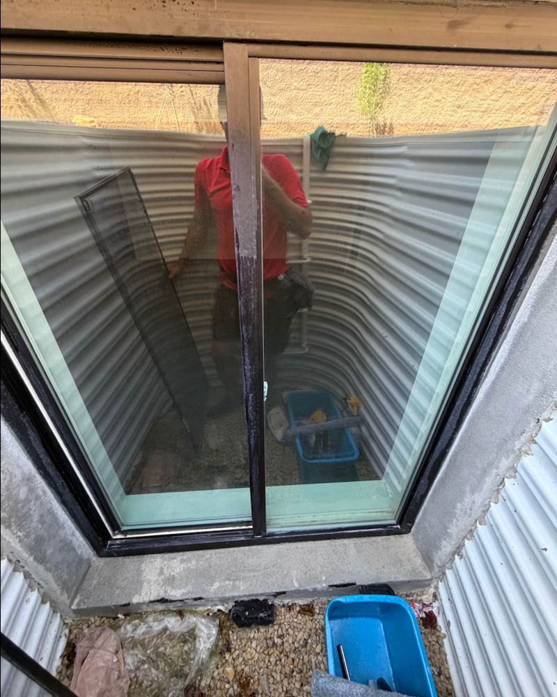 After hard water removal, the same window glass is clear.